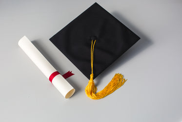 grad cap with gold tassle and red ribbon