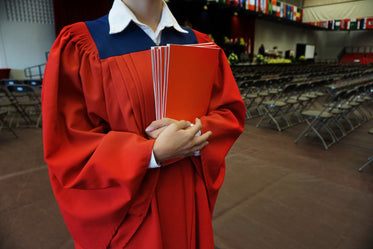 grad in gown holding programs