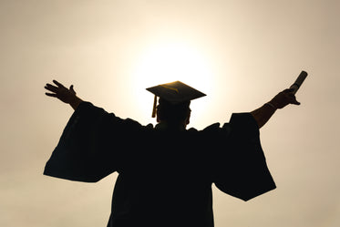 grad student with arms in the air