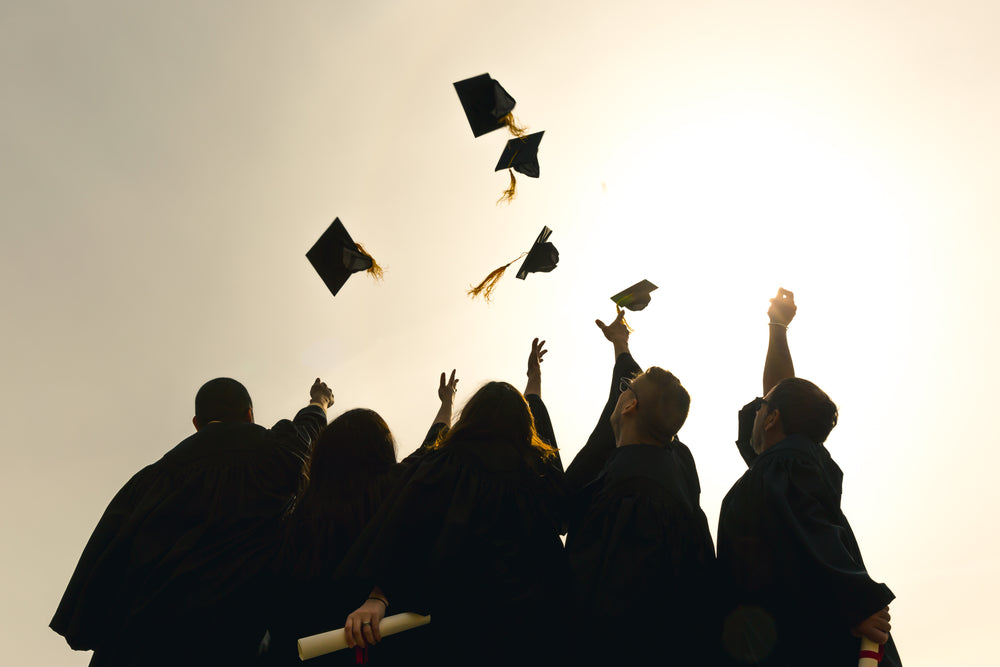 grad students throwing hats in the air