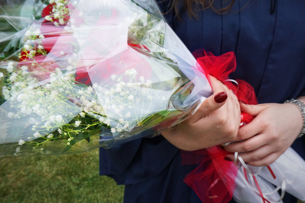 graduate with bouquet