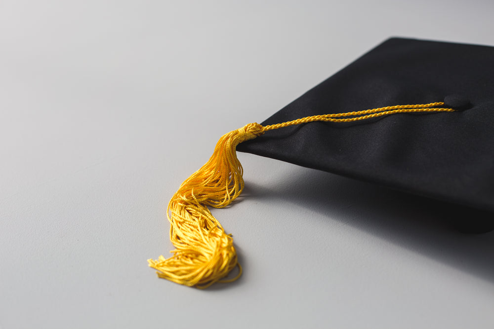 graduation cap with gold tassle