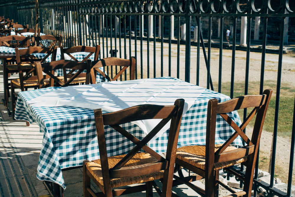 green gingham table cloth and wooden chairs