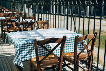 green gingham table cloth and wooden chairs