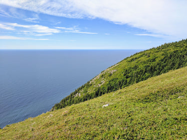 green grassy hill by the sea