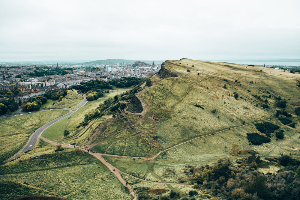 green hill by growing city