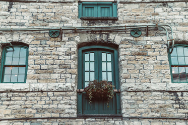 grey brick building with green door