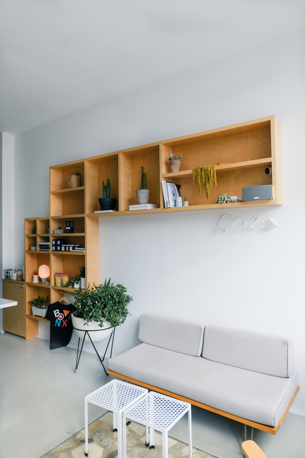 grey couch with a bookcase behind it