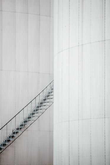 grey iron staircase between two buildings