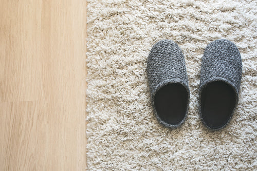 grey slippers on carpet