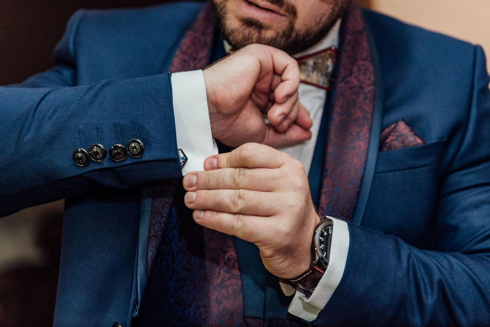 groom adjusting cufflinks