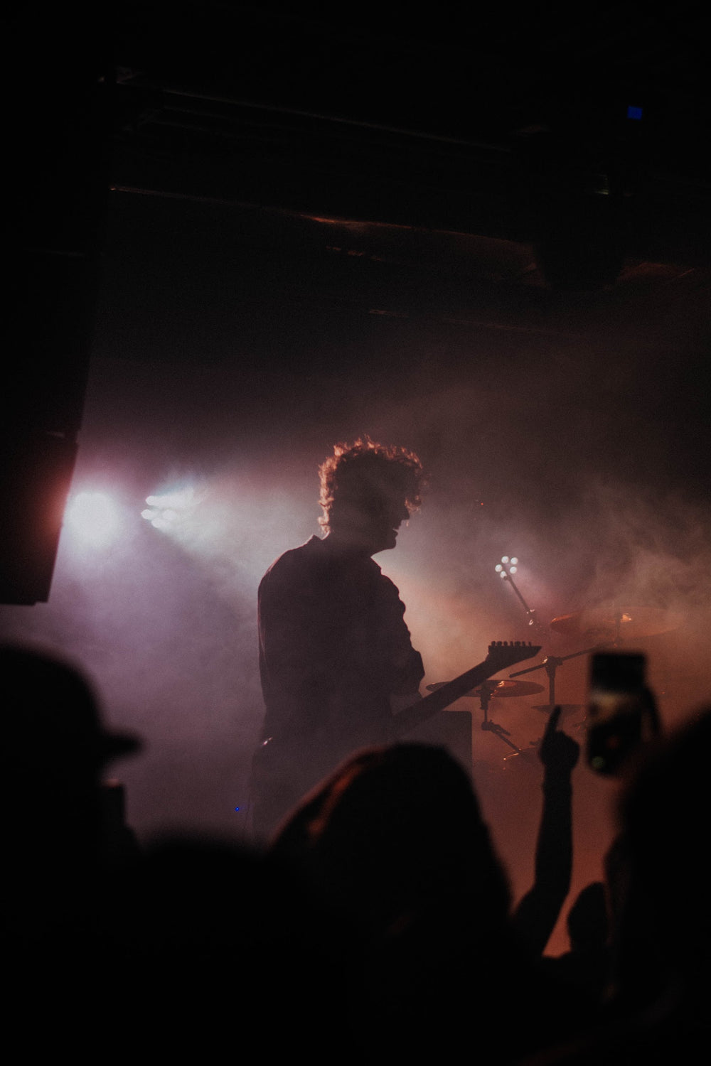 guitarist plays in a smokey venue