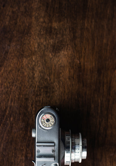 half of vintage camera viewed from overhead on wooden table