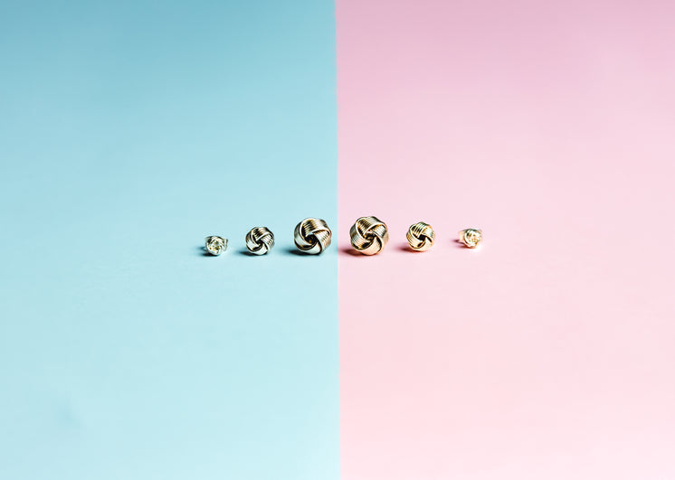 Half Pink Half Blue Background With Stud Earrings In A Row