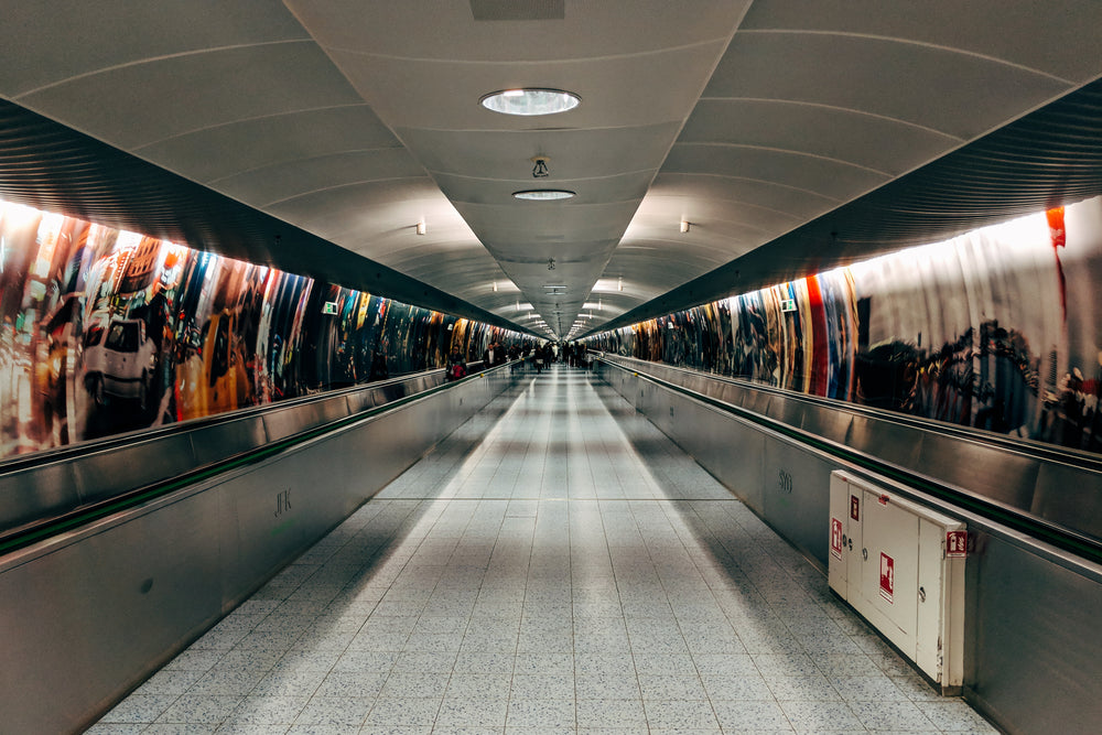 hallway with a round roof top and people at the end