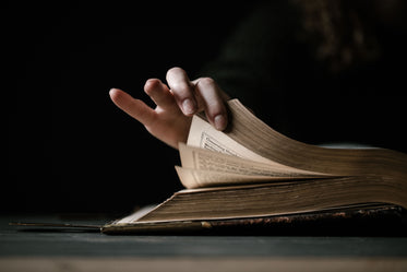 hand flips the pages of book