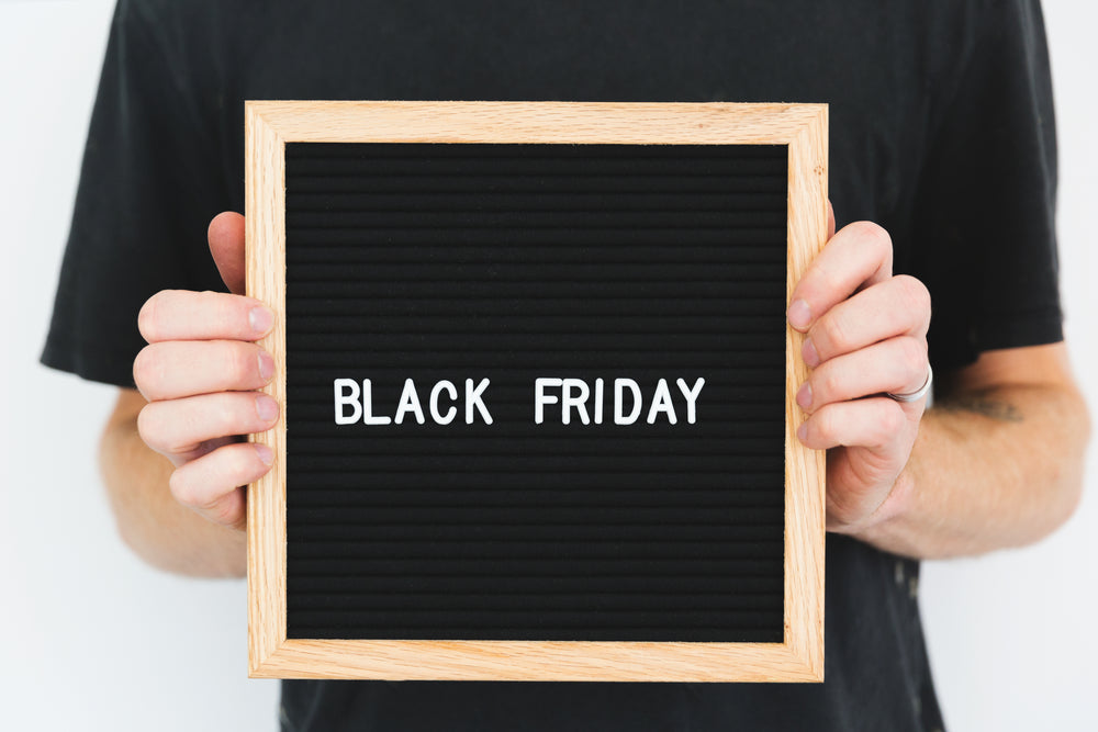 hand hold black friday sign on black