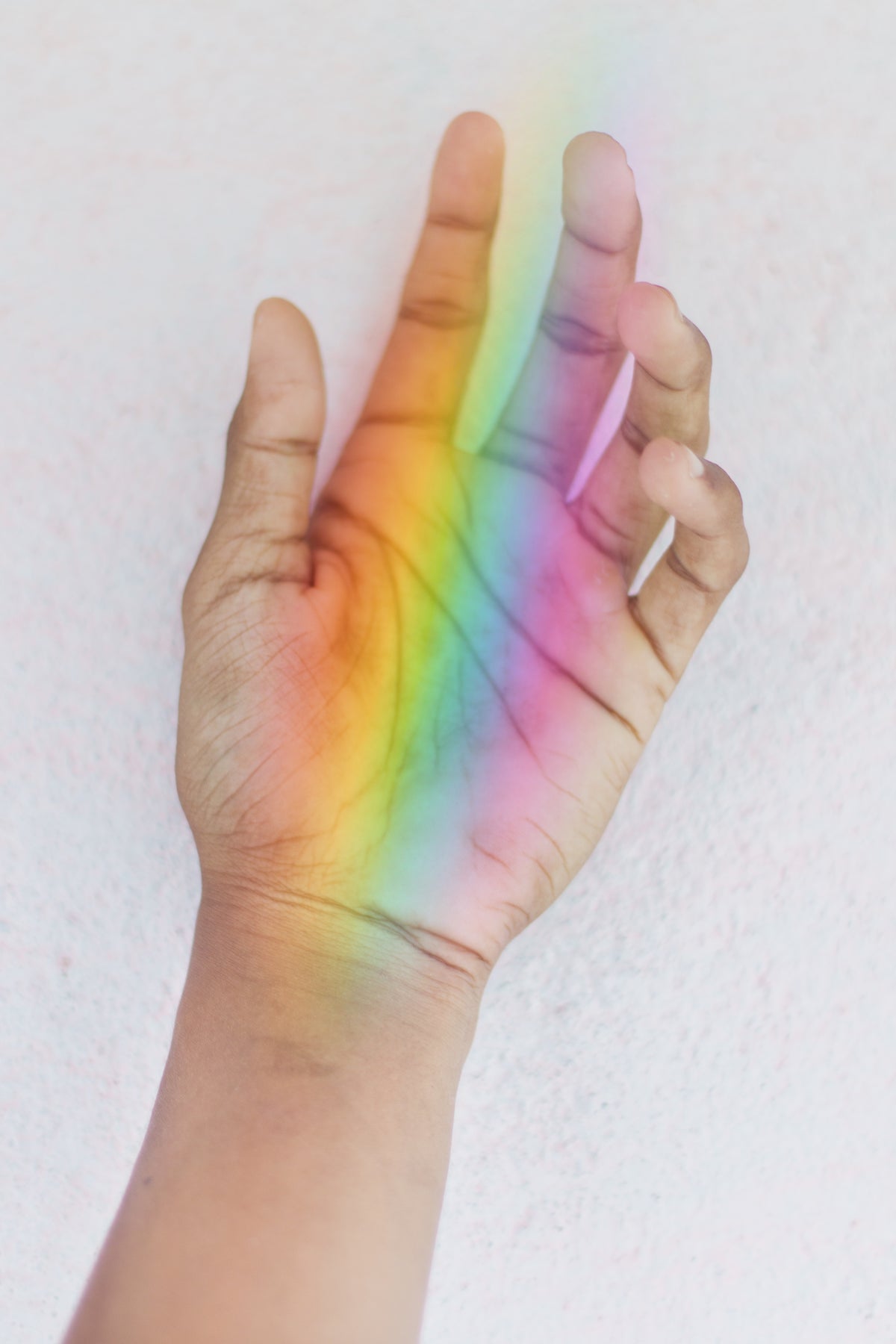 hand holding a rainbow