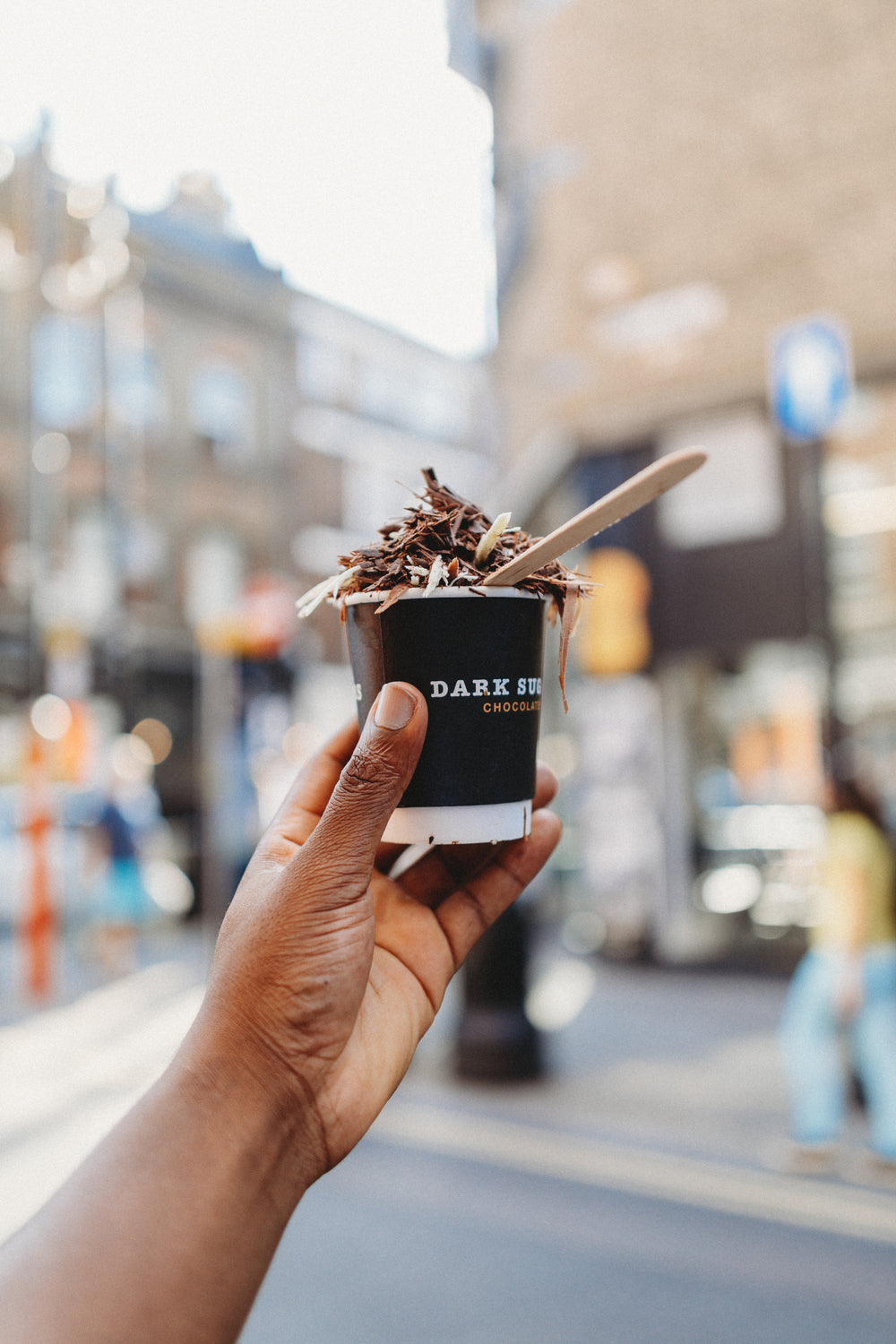 hand holding cup of chocolatey delicious