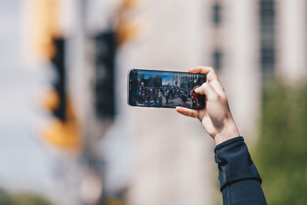 hand holding phone taking photo