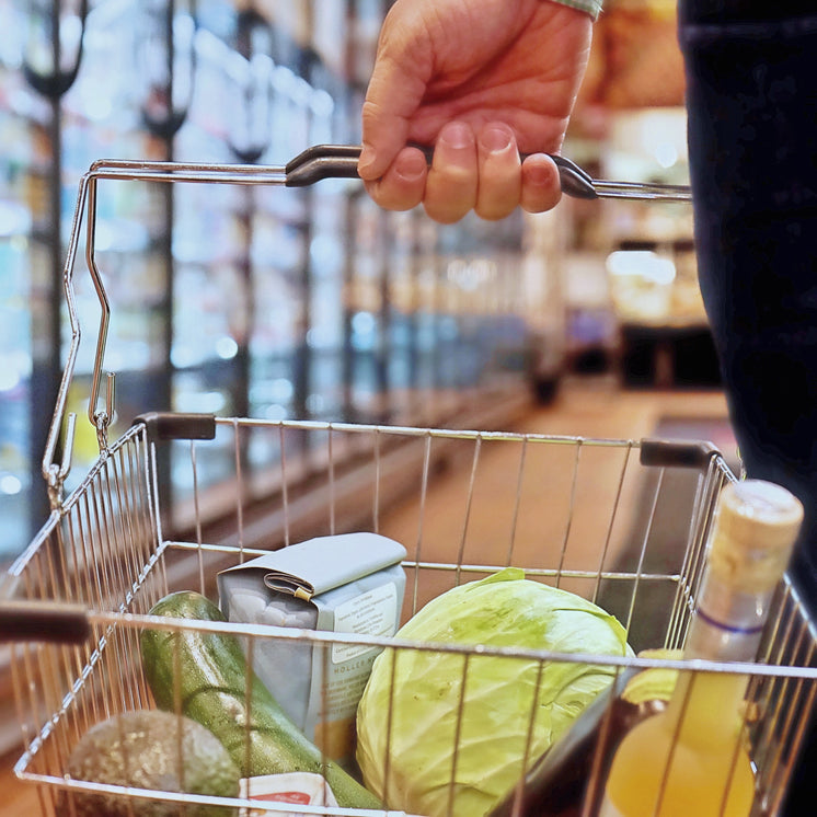 Hand Holds A Shopping Basket With Fresh Vegetables