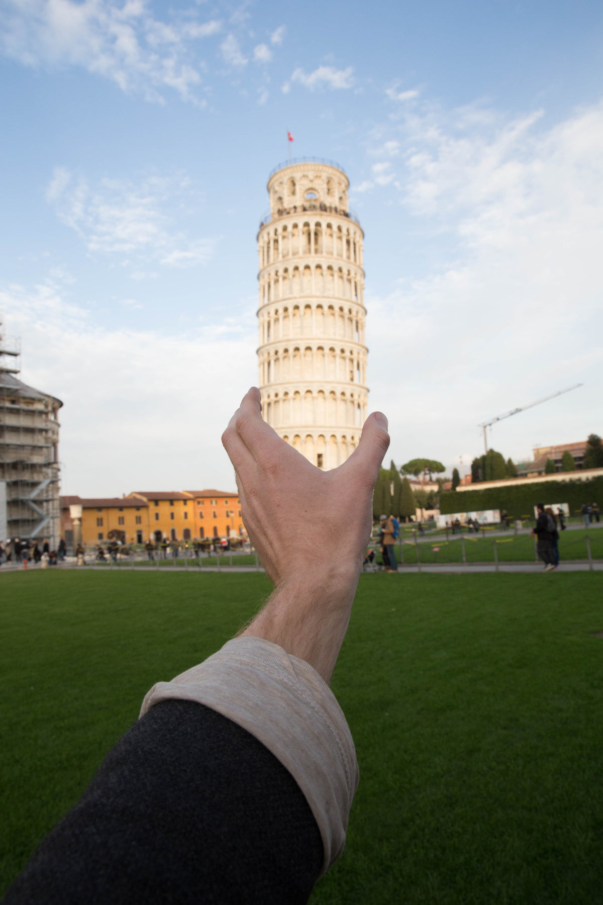 hand holds leaning tower