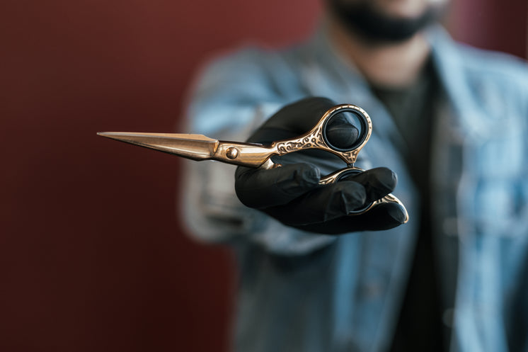 Hand Holds Out Elegant Gold Scissors