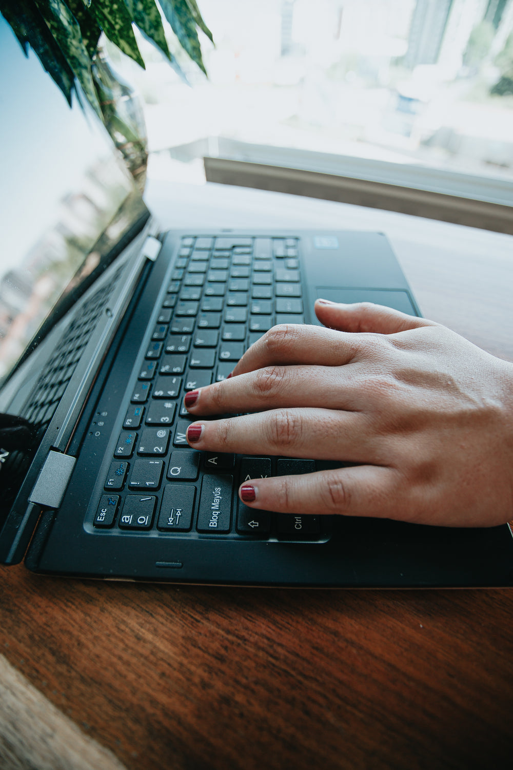 hand lays on laptop keys