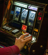 hand on slot machine