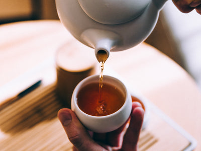 Hand Pouring Hot Tea