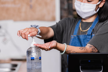 hand sanitizing while wearing a face mask