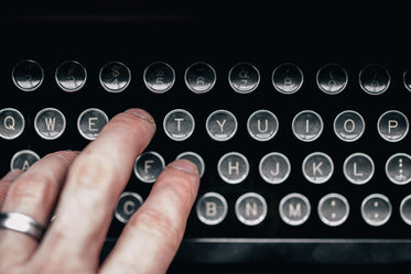 hand touching typewriter keys