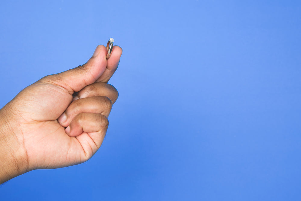 hand with ring on blue