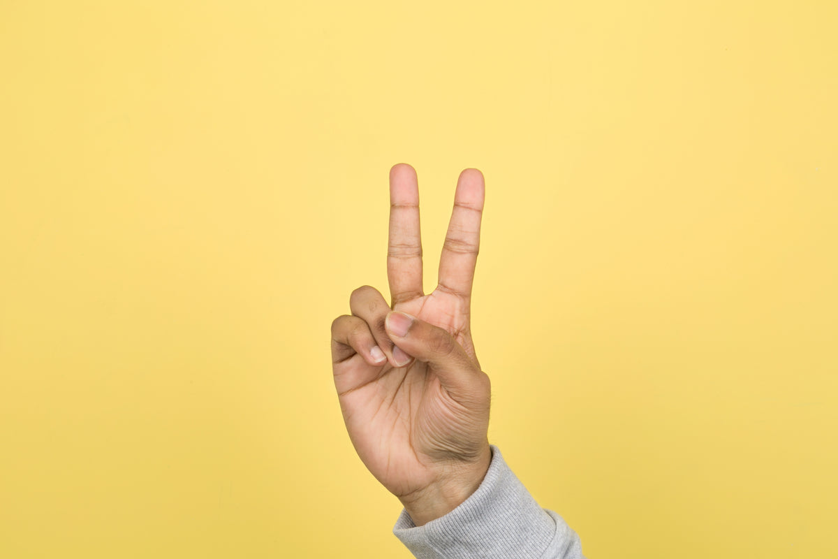 hand with two fingers up peace