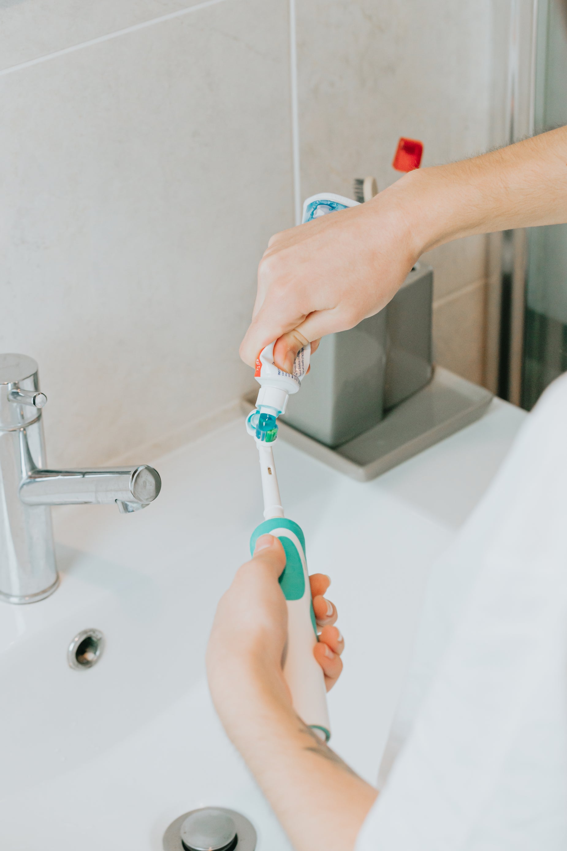 Toothbrush Add Browse Free HD Images of Hands Adding Toothpaste To An Electric Toothbrush