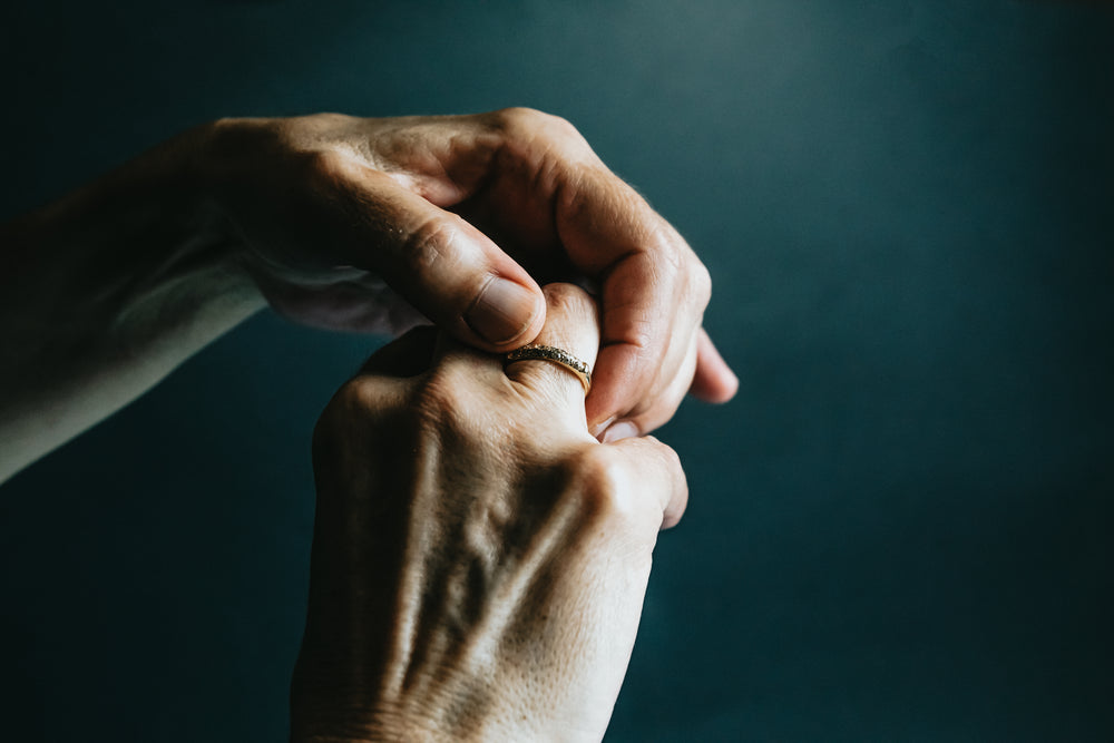 hands adjust a ring on the right ring finger