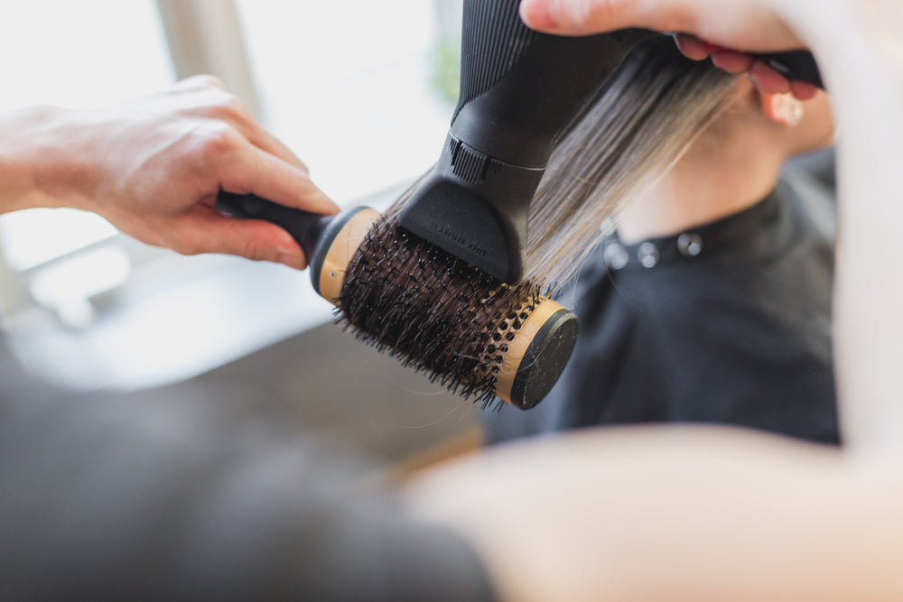 hands blow drying hair