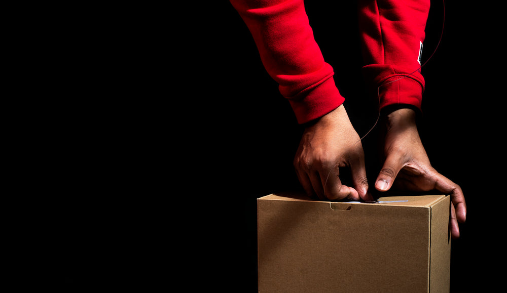 hands creating with string and box