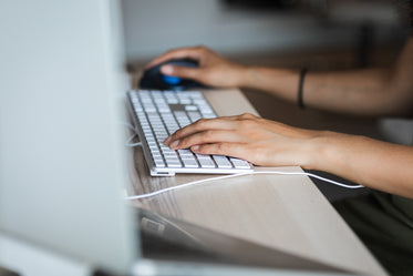 hands grasping keyboard and mouse