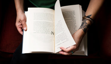 hands hold a novel and turn the page