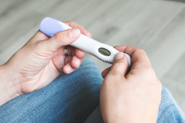 hands hold pregnancy test