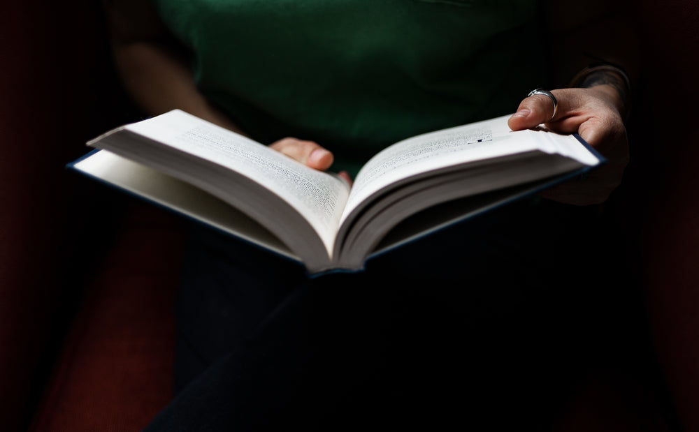 hands holding a hardcover novel