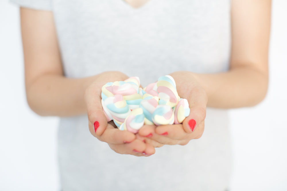 hands holding marshmallow candy