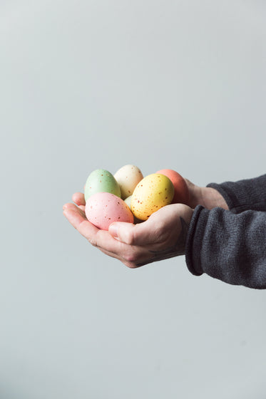 hands holding painted eggs