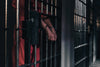 hands in handcuffs in a prison cell