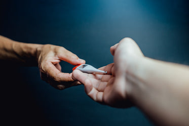 hands passing a digital thermometer