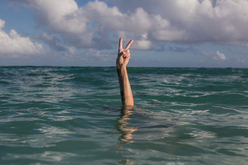 hands peace sign in water