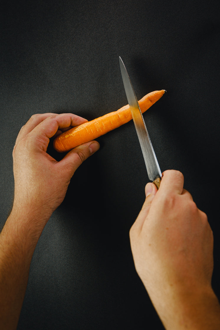 hands-prepare-to-cut-a-carrot-with-a-kni