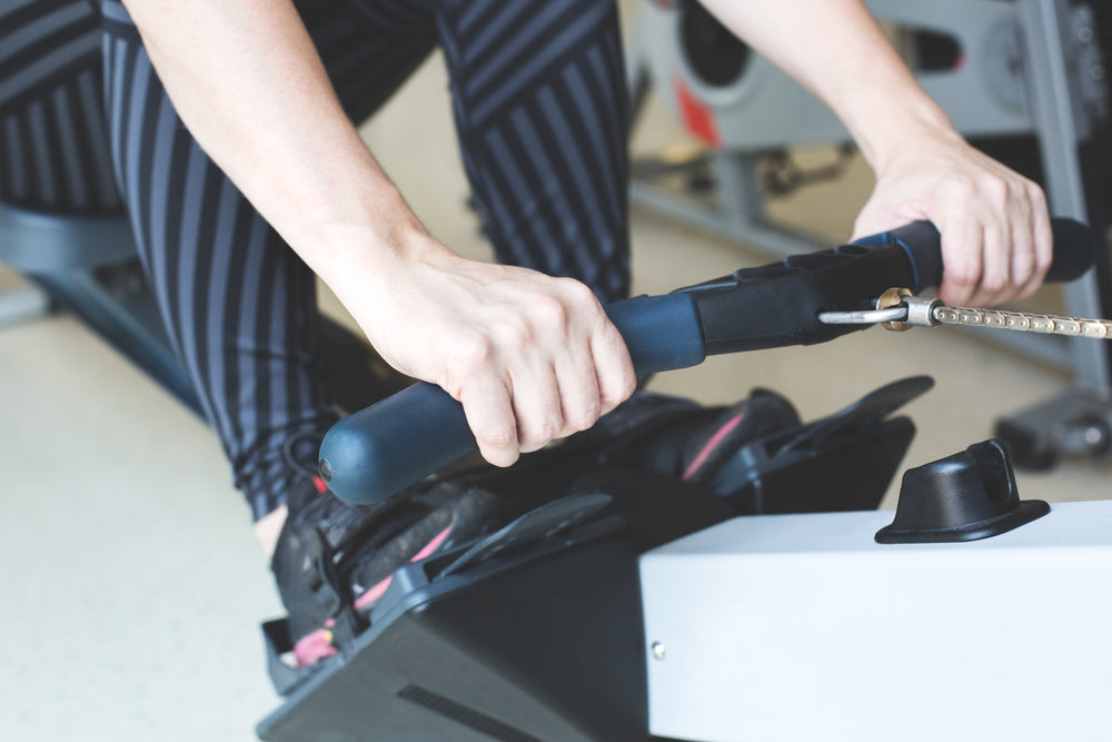 hands pulling rowing machine