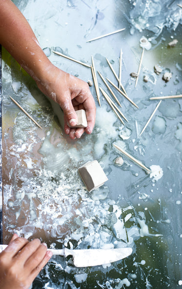 hands ready to mold block of potters clay